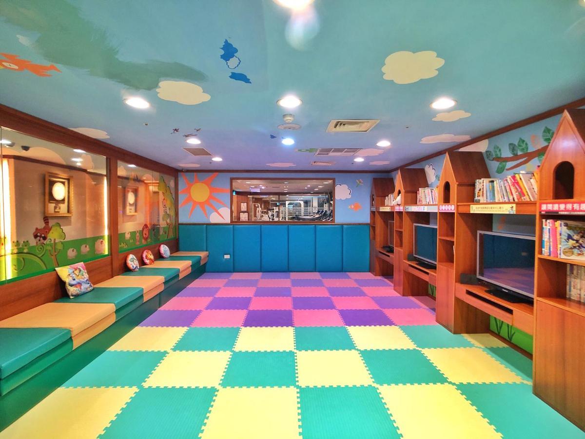 Evergreen Laurel Hotel - טאיצ'ונג מראה חיצוני תמונה The photo shows a colorful children's playroom or reading area. The ceiling is painted blue with clouds, creating a cheerful atmosphere. On the floor, there is a soft, interlocking mat with alternating pastel colors, including pink, green, and yellow